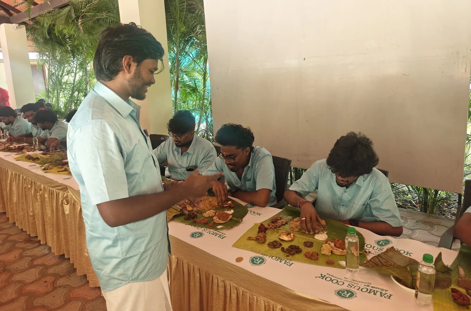 Team members sharing a meal served on banana leaves