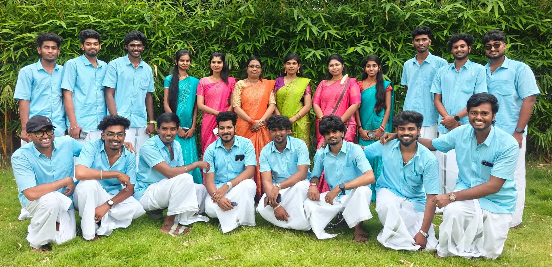 The Tranz team together outdoors in blue shirts and colourful traditional attire