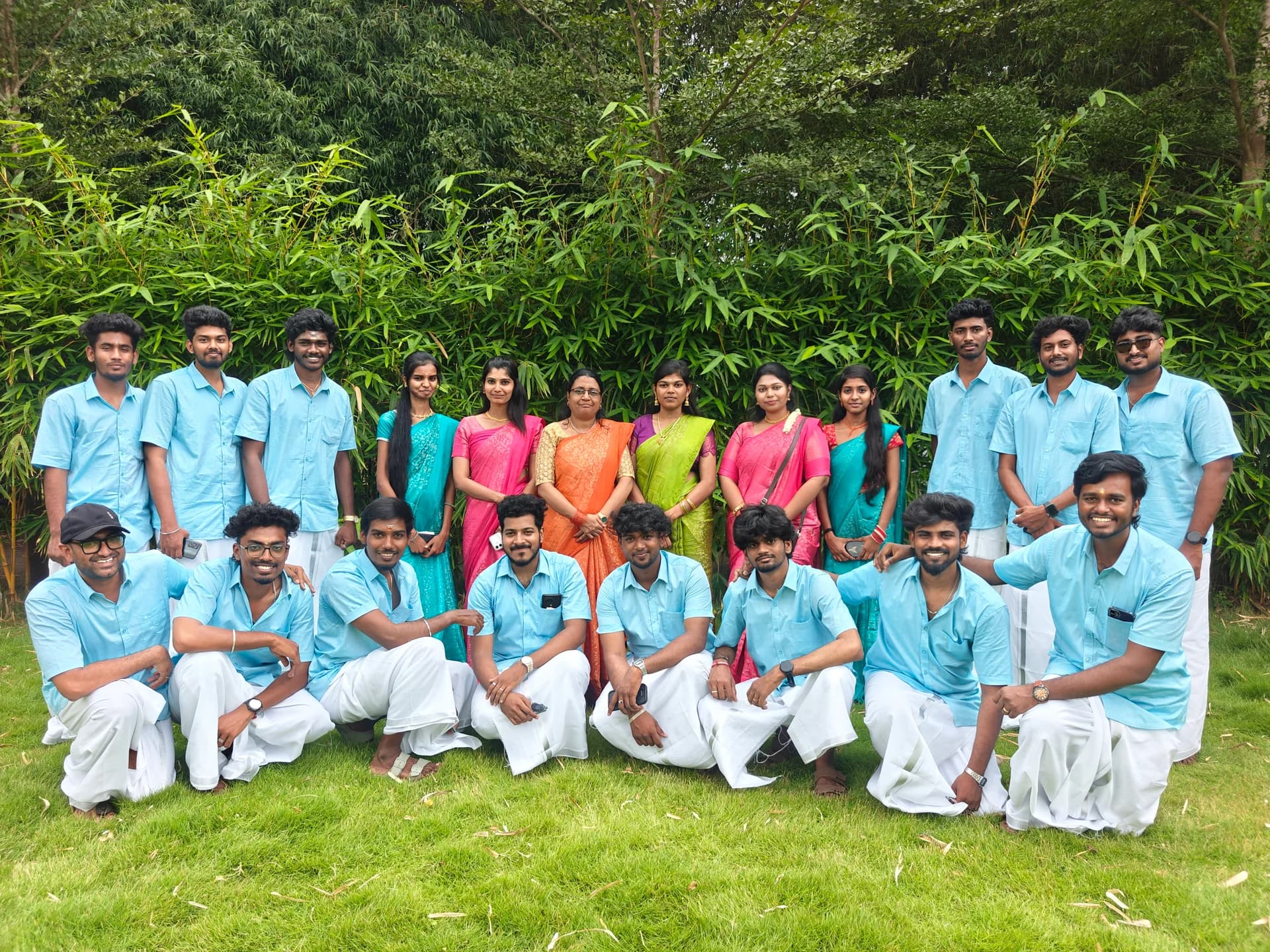 Tranz Technologies team posing together outdoors in blue shirts and colourful traditional attire